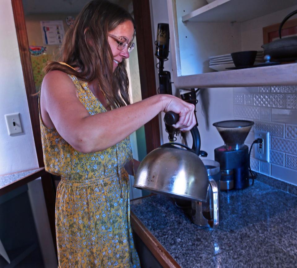 Charisse Kroner makes her morning coffee at her home on June 27. She likes using her French press. I feel like that process slows me down a little bit in the middle of a hectic morning,” she says.