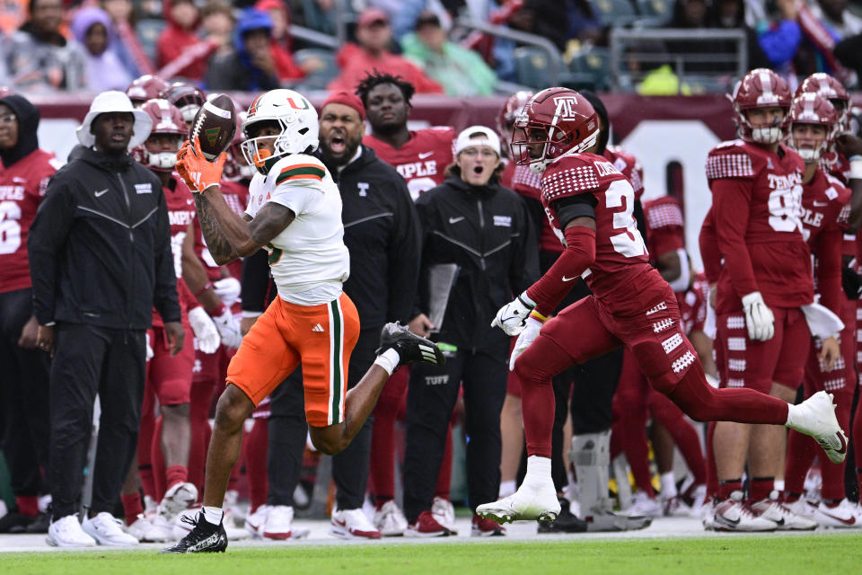 Miami wide receiver Jacolby George, left, makes a catch past Temple cornerback Corey Cuascut-Palmer during the first half of an NCAA college football game, Saturday, Sept. 23, 2023, in Philadelphia. (AP Photo/Derik Hamilton)
