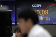 Currency traders watch computer monitors near the screen showing the Korea Composite Stock Price Index (KOSPI) at the foreign exchange dealing room in Seoul, South Korea, Wednesday, May 27, 2020. Major Asian stock markets have declined as US-Chinese tension over Hong Kong competes with optimism about recovery from the coronavirus pandemic.(AP Photo/Lee Jin-man)