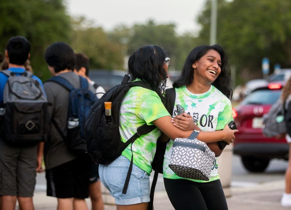 Students at Lincoln High School greet each other ahead of the start of the first day of school on Wednesday, Aug. 10, 2022 in Tallahassee, Fla. 