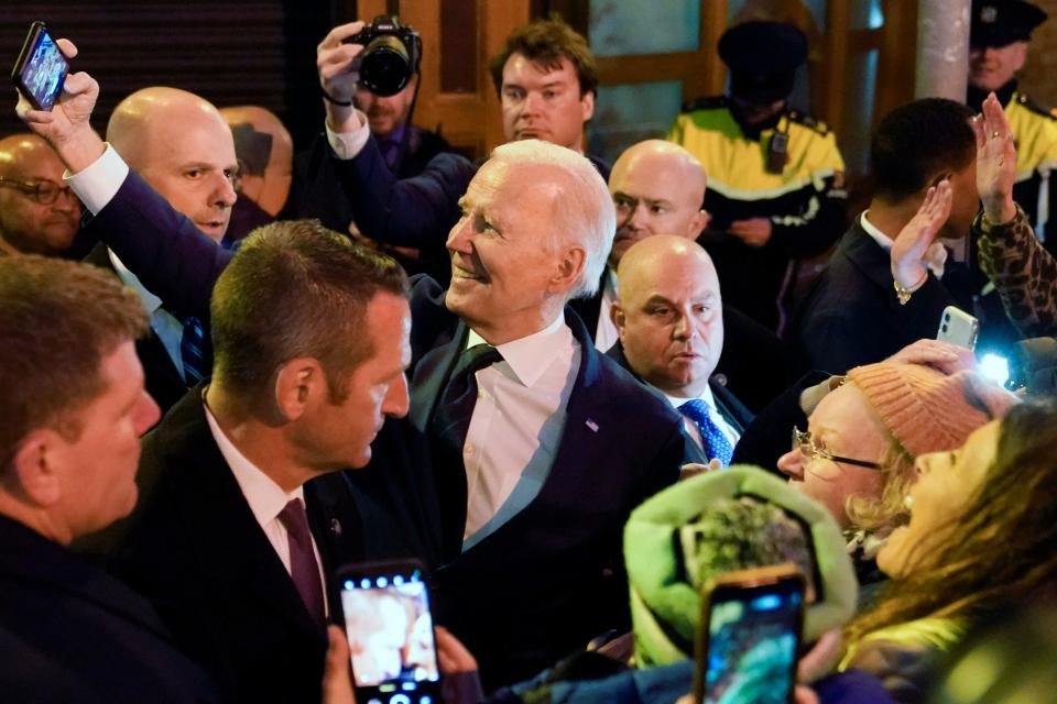 President Joe Biden takes a selfie with people in the crowd as he leaves after speaking at the Windsor Bar and Restaurant in Dundalk, Ireland, Wednesday, April 12, 2023.