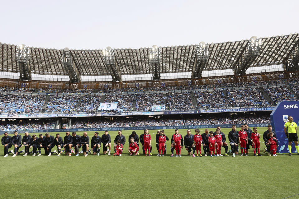 Napoli team players take the knee ahead of the Serie A soccer match between Napoli and Atalanta at the Diego Armando Maradona Stadium in Naples, Italy, Saturday, March 30, 2024. Napoli defender Juan Jesus says he has been left feeling “very bitter” and “crestfallen” by the Italian league’s decision not to punish Inter Milan player Francesco Acerbi for an allegedly racist remark toward him. (Alessandro Garofalo/LaPresse via AP)