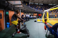 Congolese basketball player Christ Wamba rides an indoor bicycle while watching a friendly game between Aris Thessaloniki BC and Istanbul BB at the Alexandreio Melathron Nick Galis Hall in Thessaloniki, Greece, September 12, 2018. REUTERS/Alkis Konstantinidis