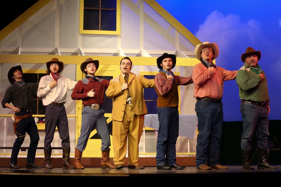 Logan Barraza, in yellow, and the male ensemble perform "It's a Scandal! It's a Outrage!" during dress rehearsal of "Oklahoma!" at Harbor Playhouse Wednesday, March 13, 2024. Barraza portrays Ali Hakim.