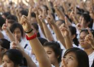 Thousands of students and faculty members dance to the theme song of the One Billion Rising campaign in the quadrangle of the St. Scholastica college in Manila February 14, 2013. One Billion Rising is a global campaign to call for an end to violence against women and girls, according to its organisers. REUTERS/Romeo Ranoco (PHILIPPINES - Tags: POLITICS SOCIETY EDUCATION)