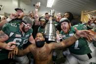 Saskatchewan Roughriders teammates celebrate inside the locker room after defeating the Hamilton Tiger-Cats in the 101st Grey Cup championship football game in Regina, Saskatchewan November 24, 2013. REUTERS/Todd Korol (CANADA - Tags: SPORT FOOTBALL TPX IMAGES OF THE DAY)