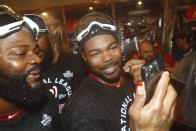 Washington Nationals' Howie Kendrick celebrates after Game 4 of the baseball National League Championship Series against the St. Louis Cardinals Wednesday, Oct. 16, 2019, in Washington. The Nationals won 7-4 to win the series 4-0. (AP Photo/Patrick Semansky)