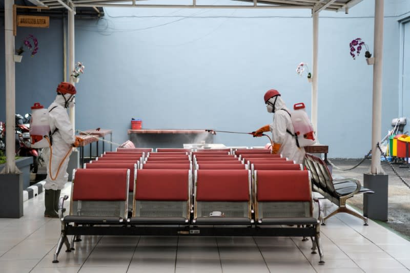 Indonesia's red cross personnel wearing protective suits spray disinfectant to prevent the spread of coronavirus disease (COVID-19) at a prison complex in Jakarta