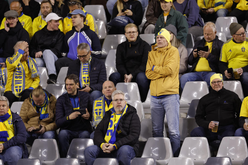 Sweden supporters react on stands during the Euro 2024 group F qualifying soccer match between Belgium and Sweden at the King Baudouin Stadium in Brussels, Monday, Oct. 16, 2023. Two Swedes were killed in a shooting late Monday in central Brussels, police said, prompting Belgium's prime minister and senior Cabinet minister to hunker down at their crisis center for an emergency meeting. (AP Photo/Geert Vanden Wijngaert)