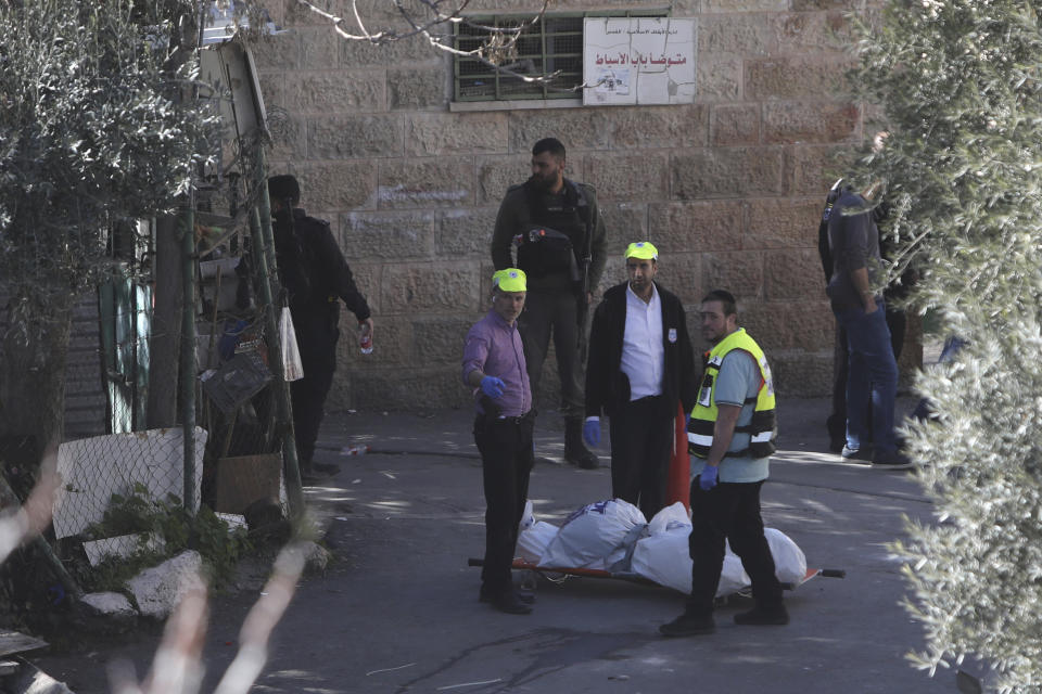 Israeli rescue workers gather around the body of a Palestinian man in the Old City of Jerusalem, Thursday, Feb. 6, 2020. Israeli police said they shot and killed the Palestinian who opened fire at forces in Jerusalem's Old City, lightly wounding an officer. (AP Photo/Mahmoud Illean)