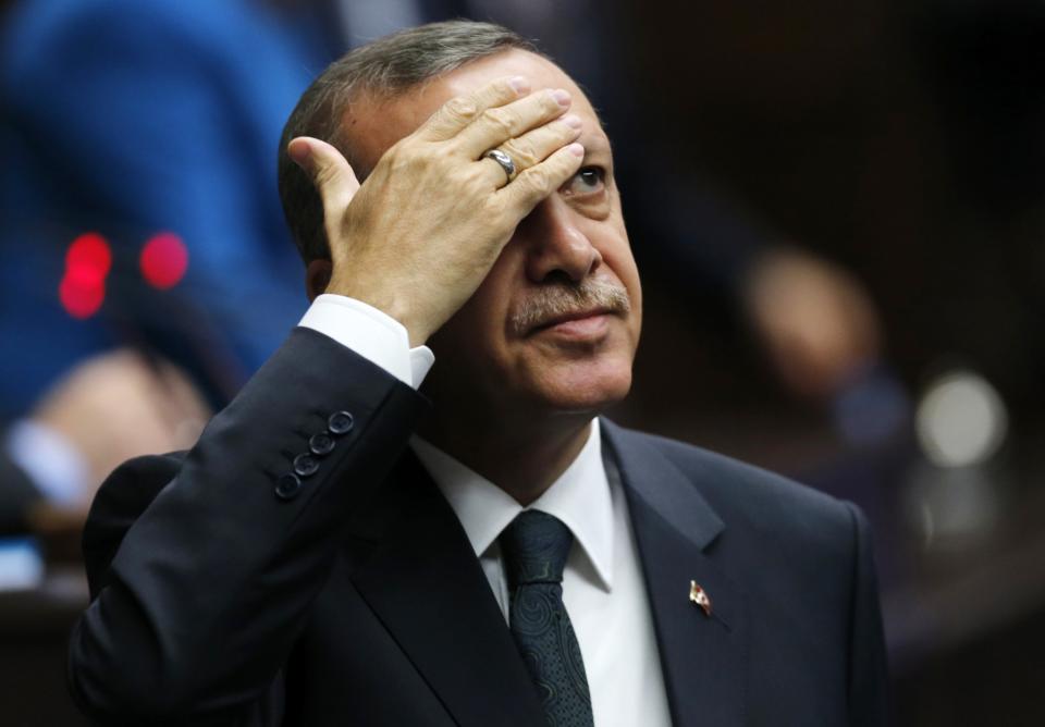 <p>Turkey’s Prime Minister Tayyip Erdogan greets members of parliament from his ruling AK Party (AKP) during a meeting at the Turkish parliament in Ankara May 20, 2014. (Umit Bektas/Reuters) </p>