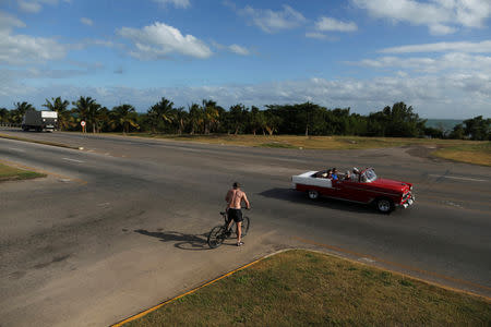 Tourists ride in a U.S. vintage car in Varadero, Cuba, December 6, 2018. Picture taken December 6, 2018. REUTERS/Fernando Medina