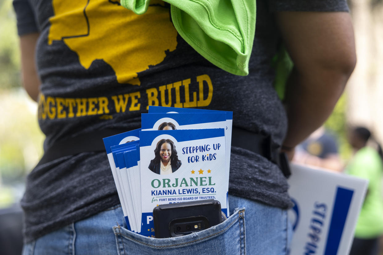 Pamphlets for school board trustee hopeful Orjanel Lewis fill the pocket of IUPAT communications director Jennifer Hernandez on Election Day on May 7, 2022, in Ft. Bend County, Texas. (Annie Mulligan for NBC News)