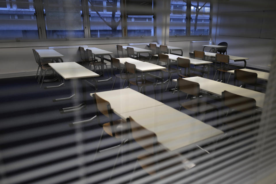 An empty classroom is pictured at the MHS, Meo High School private college, in Paris on Tuesday, Feb. 9, 2021. More than three dozen police officers descended on the small private school, blocked students inside their classrooms, took photos everywhere, even inside the refrigerator, and grilled the school director in her office. Such operations illustrate French efforts to fight extremism as lawmakers prepare to vote on a bill aimed at snuffing it out. (AP Photo/Francois Mori)