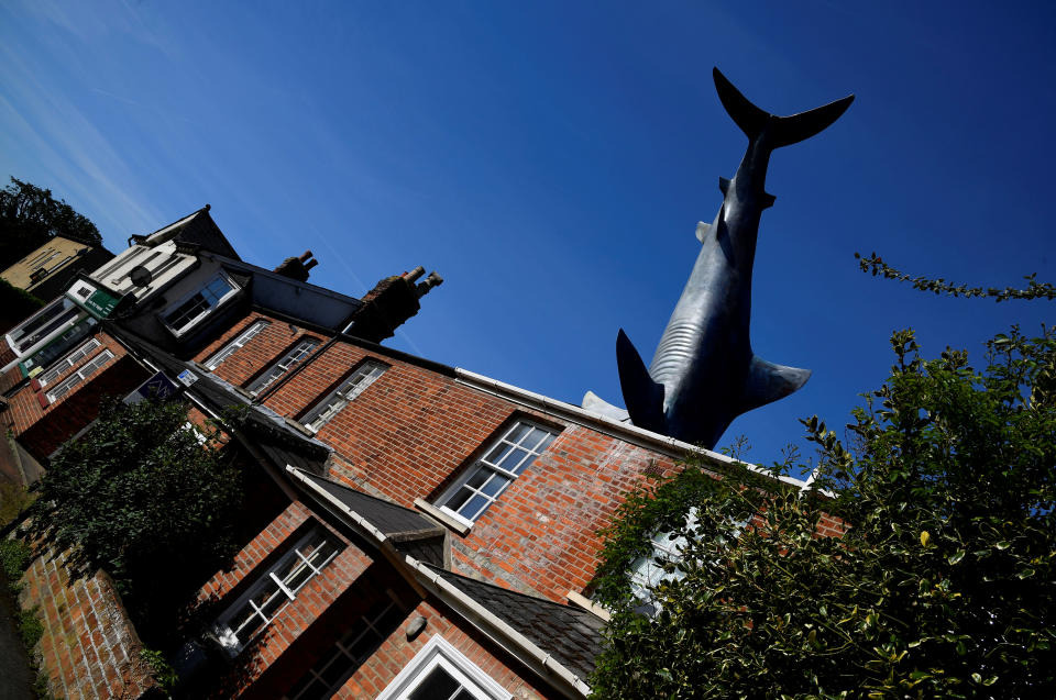 The fibreglass sculpture 'Untitled 1986', but more commonly named 'The Headington Shark', which has been on display since 1986, is seen embedded in the roof of a house in a street in Oxford, Britain, May 14, 2019. REUTERS/Toby Melville