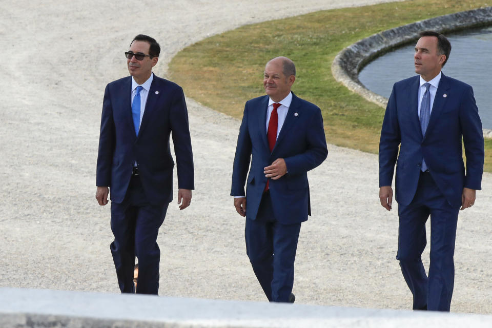 US Treasury Secretary Steve Mnuchin, German Finance Minister Olaf Scholz and Canada's Finance Minister Bill Morneau, from left, walk at the G-7 Finance in Chantilly, north of Paris, on Wednesday, July 17, 2019. The Group of Seven rich democracies' top finance officials gathered Wednesday at a chateau near Paris in search of common ground on the threats posed by digital currencies. (AP Photo/Michel Euler)