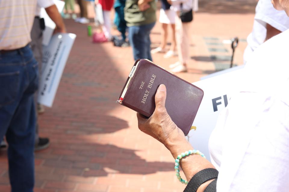 A woman holds a Bible at a pro-life rally on the steps of the Historic Capitol on Tuesday, May 24, 2022.