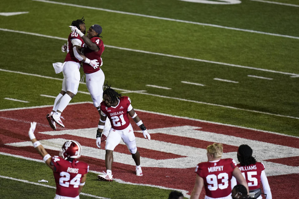 Indiana's Joseph Daniels Jr. (20), Cam Jones (4) and Noah Pierre (21) celebrate after Indiana defeated Penn State in overtime of an NCAA college football game, Saturday, Oct. 24, 2020, in Bloomington, Ind. (AP Photo/Darron Cummings)