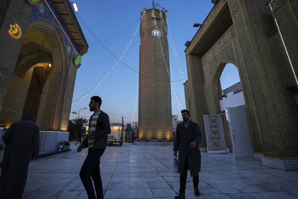 Muslim worshippers enter Abu Hanifa Mosque awaiting the announcement of the beginning of Ramadan, in Baghdad, Iraq, Sunday, March 10, 2024. Ramadan starts the day after moon sighting which marks the beginning of a new lunar month, most religious authorities in the Middle East declared Monday is the first day of the holy month of Ramadan, when observant Muslims fast from dawn to dusk. (AP Photo/Hadi Mizban)