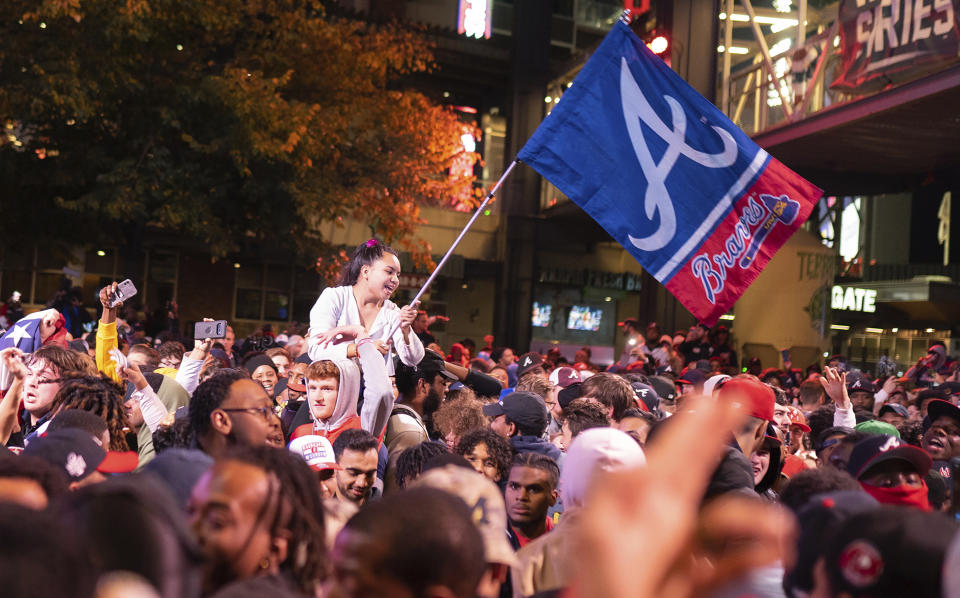 Atlanta Braves fans celebrate near Truist Park, Tuesday, Nov. 2, 2021, in Atlanta. The Atlanta Braves have won their first World Series championship since 1995, hammering the Houston Astros 7-0 in Game 6. (AP Photo/Rita Harper)