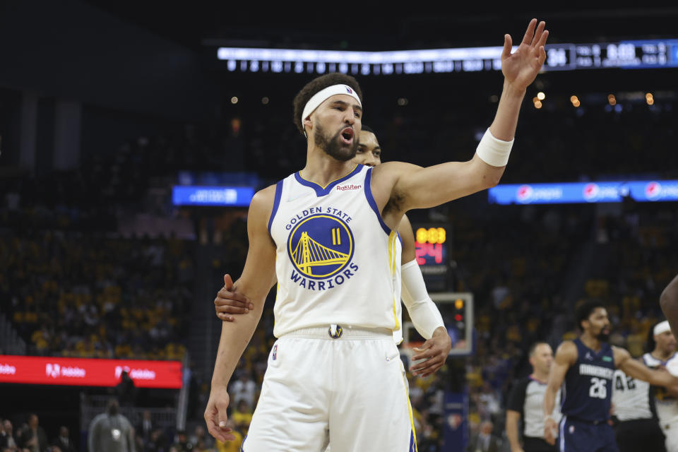 Golden State Warriors guard Klay Thompson (11) gestures toward Dallas Mavericks players during the first half of Game 2 of the NBA basketball playoffs Western Conference finals in San Francisco, Friday, May 20, 2022. (AP Photo/Jed Jacobsohn)