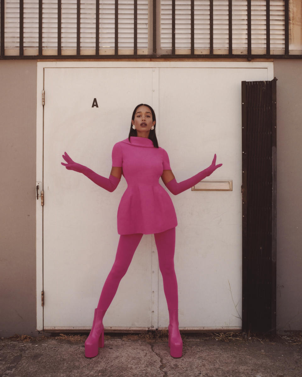 Valentino’s crepe couture dress, gloves, tights and boots. Miu Miu earrings.