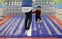 One-year-old Daichi Toyota plays with his mother at an indoor playground which was built for children and parents who refrain from playing outside because of concerns about nuclear radiation in Koriyama, west of the tsunami-crippled Fukushima Daiichi nuclear power plant, Fukushima prefecture February 27, 2014. REUTERS/Toru Hanai