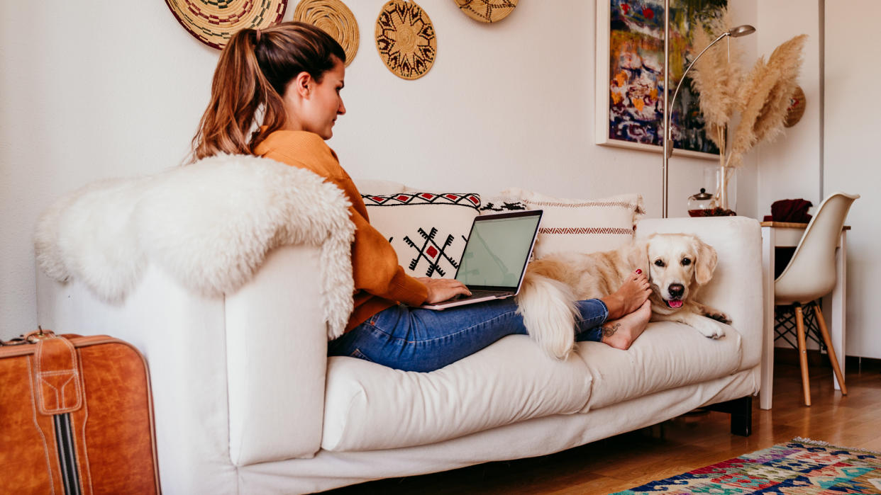 young woman working on laptop at home.