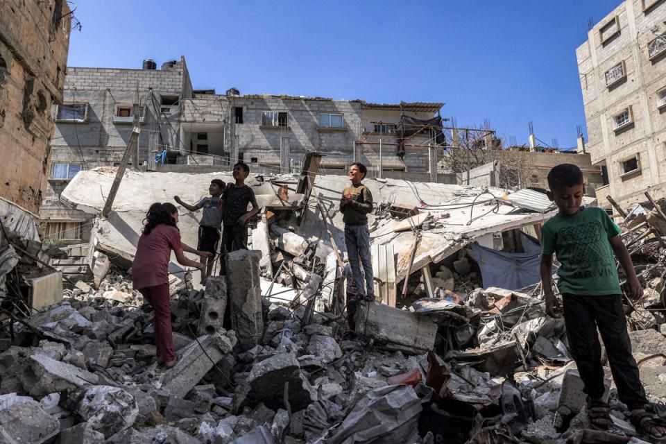 Children stand in the rubble of a collapsed building in Rafah in the southern Gaza Strip (AFP via Getty Images)