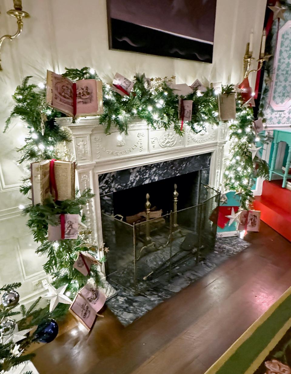 Mindy Shubert Geist help adorn a mantel at the White House with decorations made to look like open books.