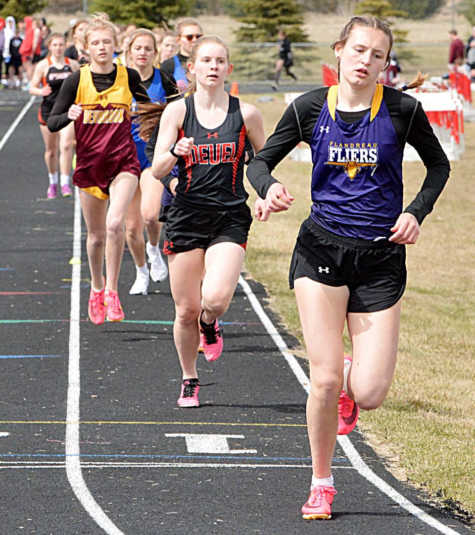 Flandreau's  Faith Wiese leads Jaycee Hourigan of Deuel in a heat of the girls' 1,600-meter run during the Pat Gilligan Alumni track and field meet on Tuesday, April 25, 2023 in Estelline.