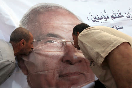 File photo shows supporters of former presidential candidate Ahmed Shafik kissing his poster during a protest at Nasr City in Cairo, Egypt, June 23, 2012. REUTERS/Amr Abdallah Dalsh/File Photo