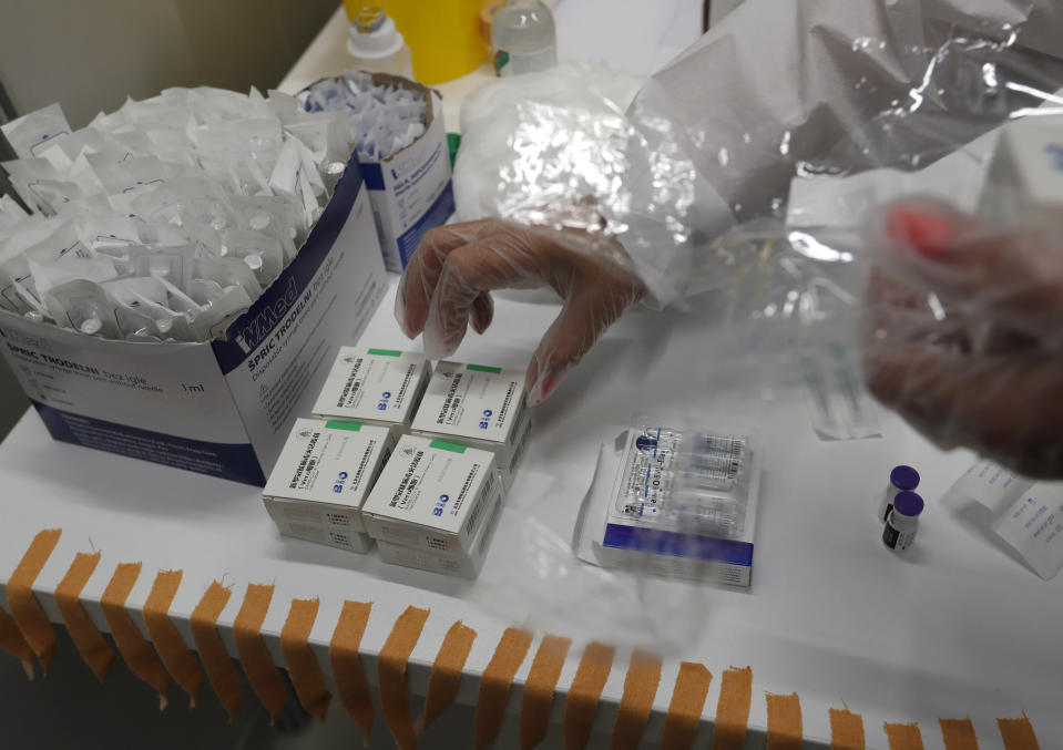 A medical worker prepares vials of the COVID-19 vaccines, Chinese Sinopharm, left, Sputnik V, center, and Pfizer at a vaccine centre, in the Usce shopping mall in Belgrade, Serbia, Thursday, May 6, 2021. Serbian authorities are looking for incentives for people to boost vaccination that has slowed down in recent weeks amid widespread anti-vaccination and conspiracy theories in the Balkan nation. The government has also promised a payment of around 25 euros to everyone who gets vaccinated by the end of May. (AP Photo/Darko Vojinovic)