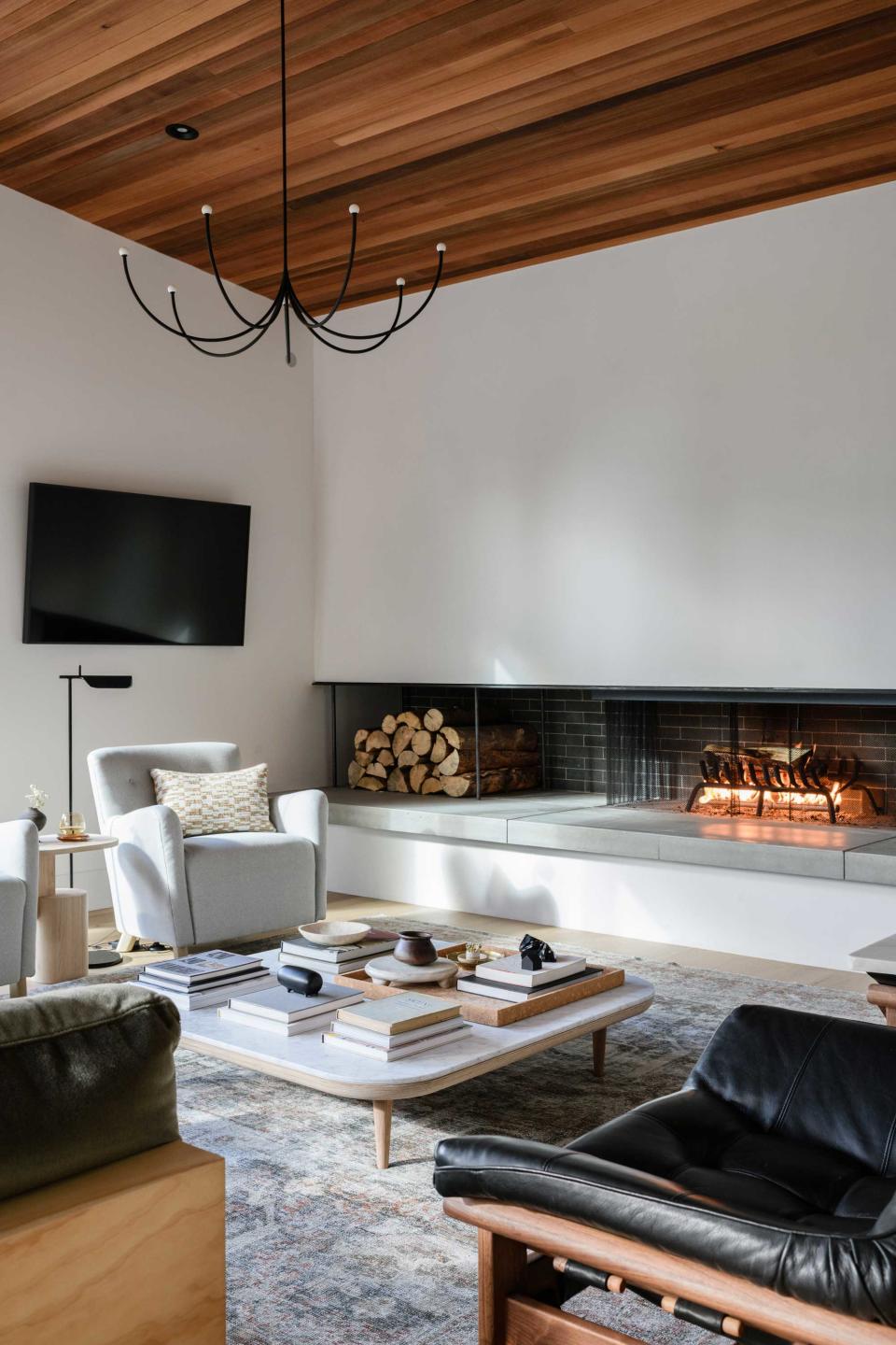 a tall living room with a chandelier