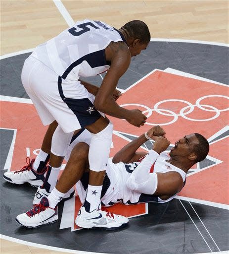 United States' Kevin Durant and Chris Paul celebrate during the men's gold medal basketball game against Spain at the 2012 Summer Olympics, Sunday, Aug. 12, 2012, in London.