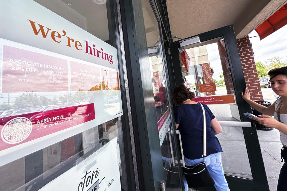 A hiring sign is displayed at a beauty retail store in Arlington Heights, Ill., Tuesday, May 21, 2024. (AP Photo/Nam Y. Huh)