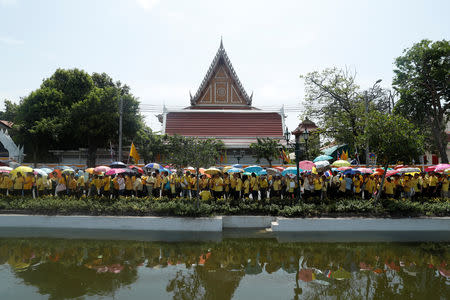 People stand in line to pass through a security check before attending a coronation procession for Thailand's newly crowned King Maha Vajiralongkorn near the Grand Palace in Bangkok, Thailand May 5, 2019. REUTERS/Jorge Silva