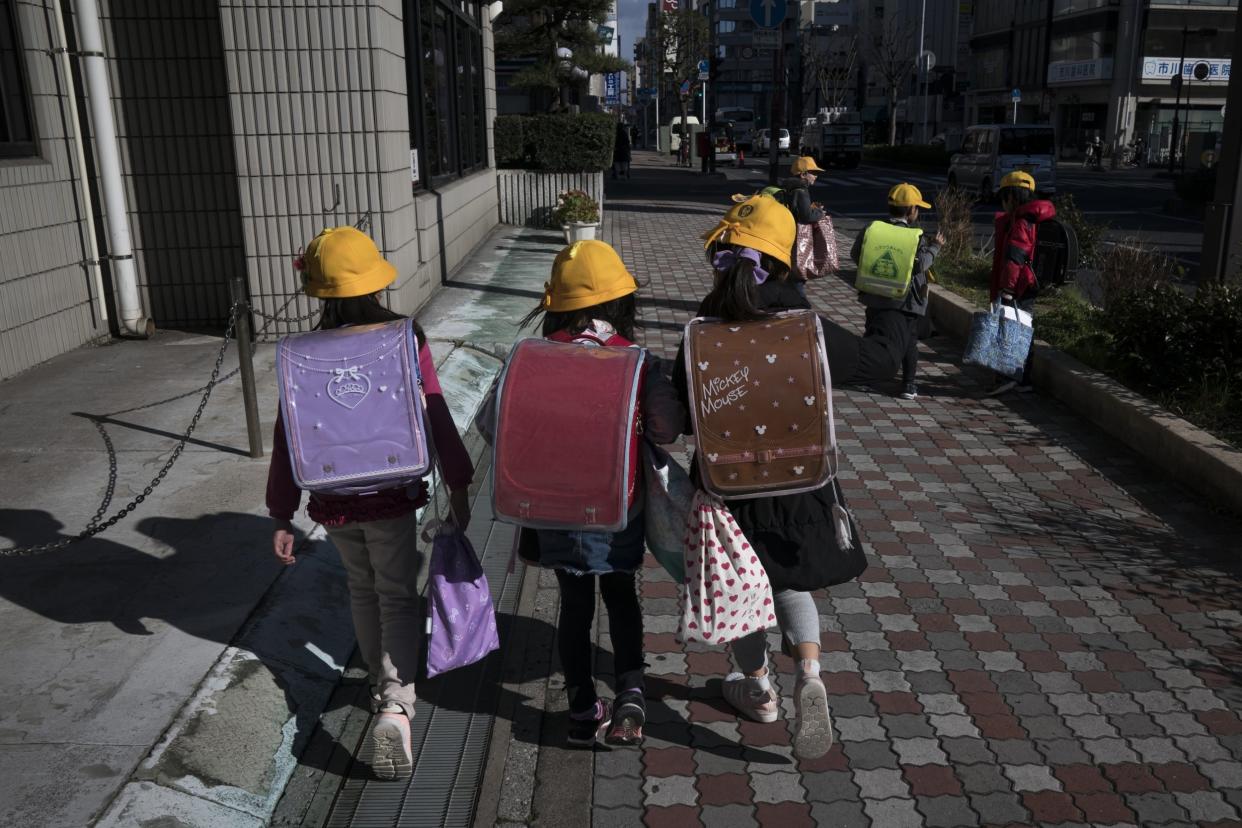 Elementary school students make their way home on February 27, 2020 in Ichikawa, Japan: Getty Images