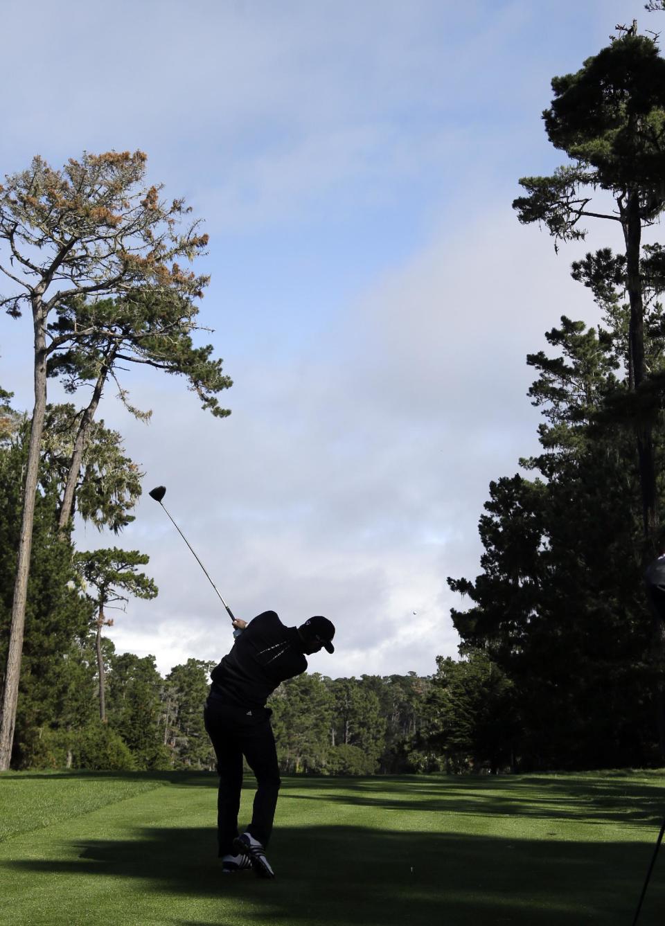 Dustin Johnson hits off the seventh tee on Thursday, Feb. 6, 2014, during the first round of the AT&T Pebble Beach Pro-Am golf tournament on the Spyglass Hill Golf Course in Pebble Beach, Calif. (AP Photo/Ben Margot)