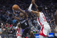 Houston Rockets center Christian Wood (35) guards Sacramento Kings guard De'Aaron Fox (5) during the second half of an NBA basketball game in Sacramento, Calif., Friday, Jan. 14, 2022. The Kings won 126-114. (AP Photo/Randall Benton)