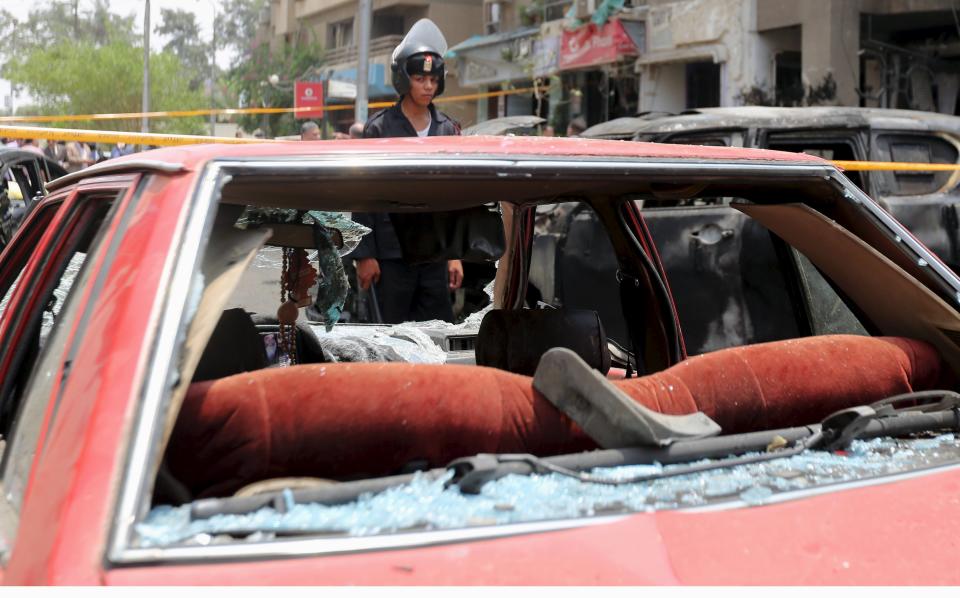 A car damaged as a result of a car bomb attack on the convoy of Egyptian public prosecutor Hisham Barakat near his house at Heliopolis district, is seen in Cairo