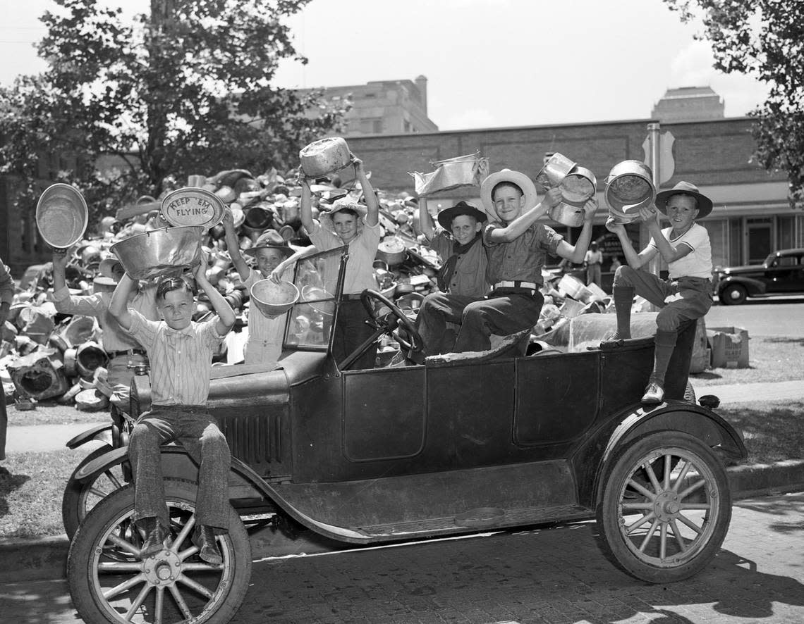 July 28, 1941: Holding some of the aluminum pieces they collected from Everman, Texas, residents are seven Boy Scouts from Troop 120, with the Model T car that brought them to the Fort Worth collection center at Peter Smith Park. The aluminum donations will be used for the national defense program. Behind them is a pile of the aluminum collected so far. At the far left, front, is Cecil Corn, 11. Others, left to right, are Roy Thomas, 12 (directly behind Corn); Weldon Pittman, 13; Earl Ray Smithey, 10; Robert Lee Wylie, 12; Edwin Smithey, 13; and Billy Owen, 13. Fort Worth Star-Telegram archive/UT Arlington Special Collections