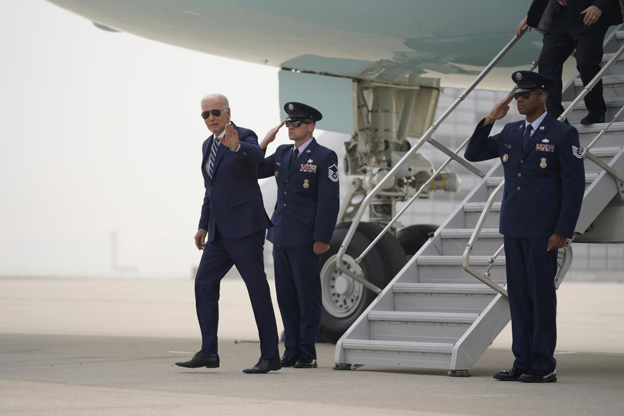 President Joe Biden arrives at O’Hare International Airport where smoke from Canadian wildfires has blanketed the city (AP)