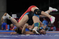 FILE - In this Aug. 2, 2021, file photo, Germany's Anna Carmen Schell, right, compete against Egypt's Enas Ahmed during their women's 68kg freestyle wrestling match at the 2020 Summer Olympics in Chiba, Japan. Tokyo Olympians are exercising extraordinary discipline against the coronavirus. They are sealed off in a sanitary bubble that has made competition possible but is also squeezing a lot of fun from their Olympic experience. (AP Photo/Aaron Favila, File)