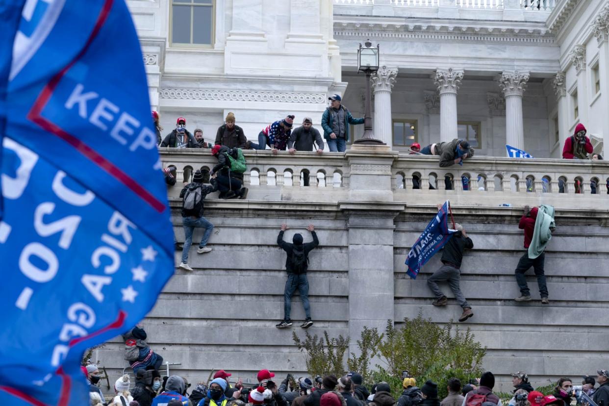 Image: Protesters climb Capitol wall  (Jose Luis Magana / AP)