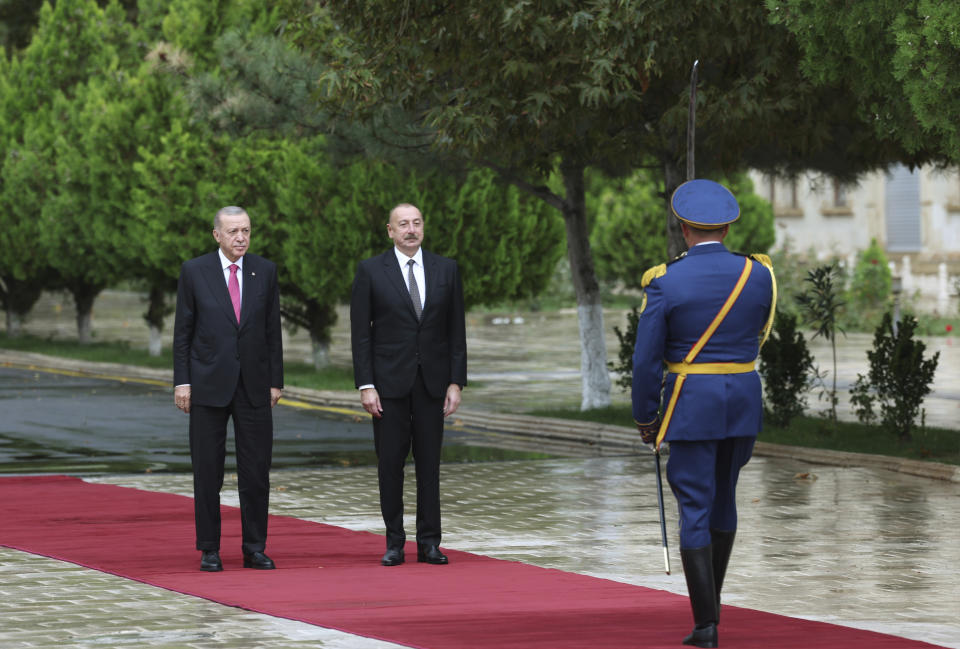 In this handout photo released by Turkish Presidency, Azerbaijan's President Ilham Aliyev, right, and Turkey's President Recep Tayyip Erdogan review an honor guard during a welcome ceremony in Nakhchivan, Azerbaijan, Monday, Sept. 25, 2023. Thousands of Armenians streamed out of Nagorno-Karabakh after the Azerbaijani military reclaimed full control of the breakaway region while Turkish President Recep Tayyip Erdogan visited Azerbaijan Monday in a show of support to its ally. (Turkish Presidency via AP)