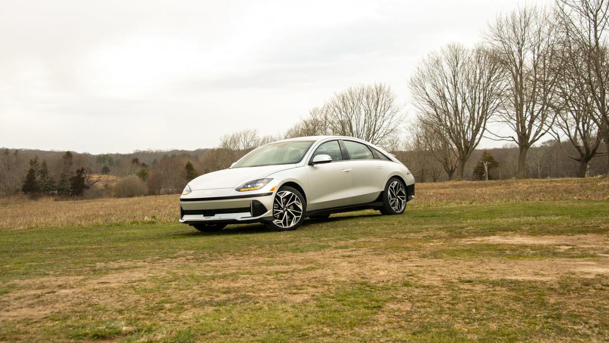 a silver four door sedan parked on the grass