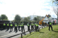 Police maintain a loose cordon as emergency services use a cherry picker to attempt to remove protesters and dismantle the bamboo lock-ons they are using to block the road outside the Newsprinters printing works at Broxbourne, Hertfordshire. (Photo by Yui Mok/PA Images via Getty Images)