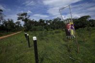 FILE - A campaign sign of President Jair Bolsonaro stands next to a farm fence on the access road to the Chico Mendes Extractive Reserve, in Xapuri, Acre state, Brazil, Dec. 6, 2022. Parts of Amazon region, with its legacy of rubber tappers, have turned against his Workers' Party and its vision of a sustainable economy. Many prefer to cut forest and run cattle and have became supporters of Bolsonaro. (AP Photo/Eraldo Peres, File)