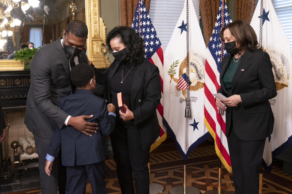 Vice President Kamala Harris, right, watches EPA administrator Michael Regan gives his wife Melvina Thomas Regan and son Matthew Silas, 7 a hug, during a ceremonial swearing-in ceremony in the Vice President's Ceremonial Office at the Eisenhower Executive Office Building on the White House complex in Washington, Wednesday, March 17, 2021. (AP Photo/Manuel Balce Ceneta)